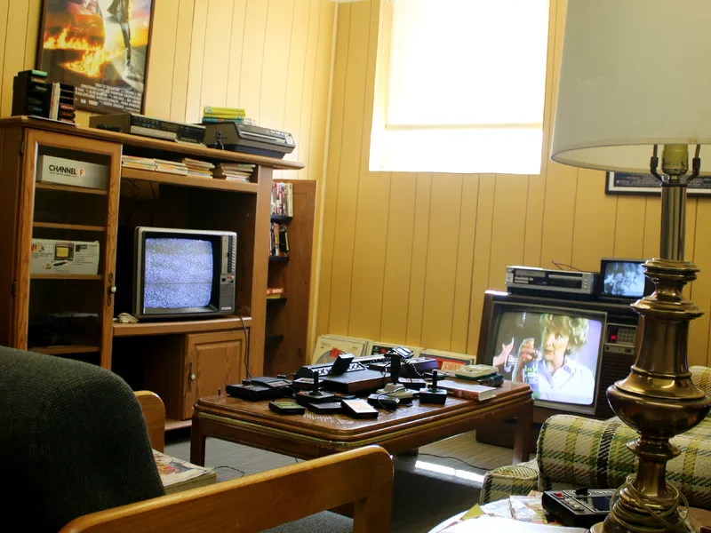 A wood-panelled den full of old TVs and stereo gear